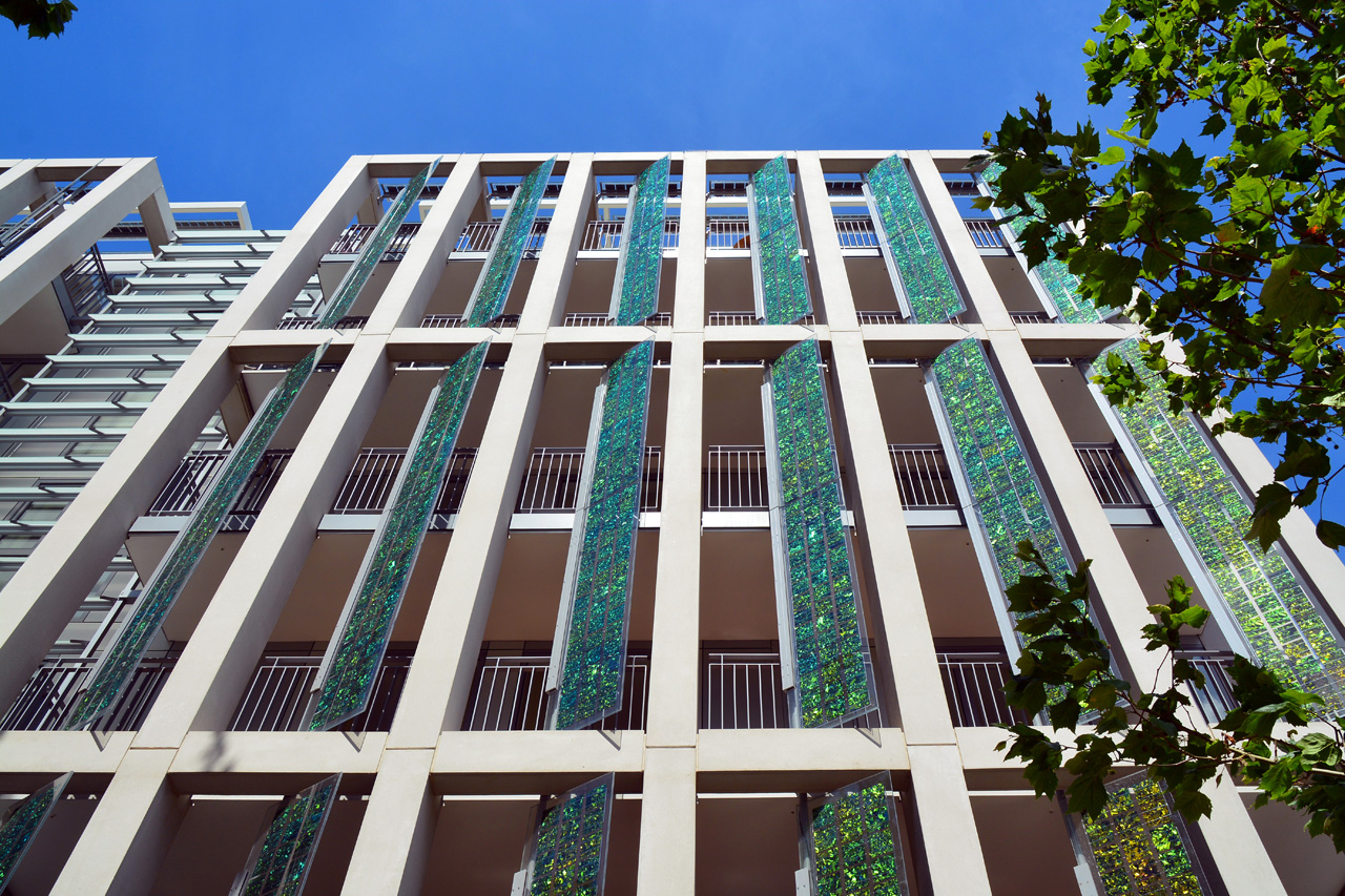 Kingsgate House on King’s Road, with white balconies and patterned green facade panels